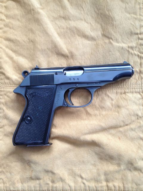 1992 Ford Mustang - Close-up of a Walther PPK pistol, showing the grip and slide markings.