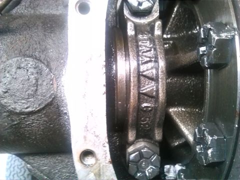 1992 Ford Bronco - A close-up view of an engine's connecting rod, showing stamped markings including the year 1992.