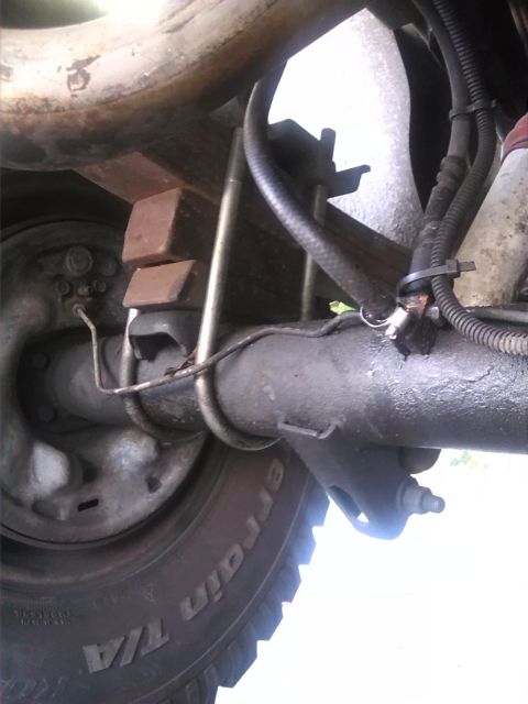 1992 Ford Bronco - Undercarriage view showing the rear axle assembly and suspension components of a vehicle.