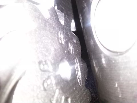 1992 Ford Bronco - A detailed view of a mechanical component, likely a gear, showing its intricate teeth.