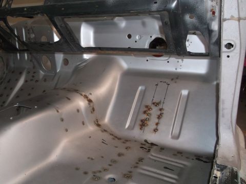 1967 Ford Mustang - The interior floor pan of a vehicle is shown, appearing to be undergoing restoration or repair.