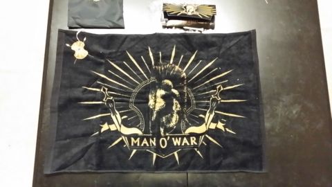 2007 Subaru Impreza - A black flag with a gold graphic and text is laid out on a table next to other items.
