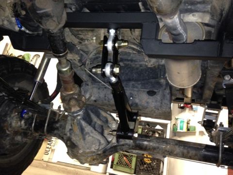 1987 Suzuki Samurai - Underside view of a vehicle's rear axle showing an installed anti-wrap bar and suspension components.