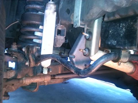 1992 Ford Bronco - Undercarriage view shows suspension parts including a shock absorber and sway bar.