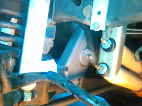 1992 Ford Bronco - Undercarriage view shows suspension parts, including a shock absorber and springs, with a metal bracket attached.