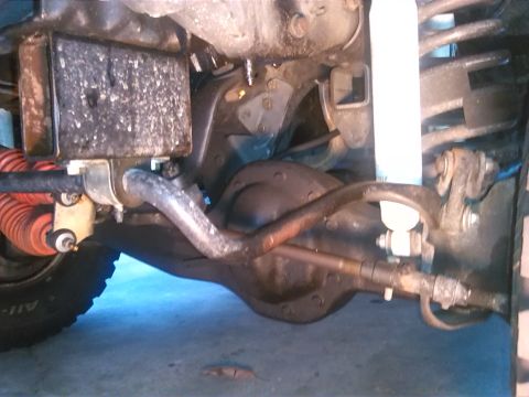 1992 Ford Bronco - Close-up view of the rear axle and suspension system of a vehicle.