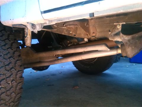 1992 Ford Bronco - Close-up view of the undercarriage and suspension system of an unidentified vehicle.