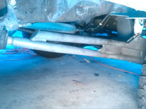 1992 Ford Bronco - A close-up view of a vehicle's undercarriage, showing suspension and exhaust systems.