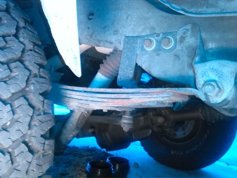 1992 Ford Bronco - Undercarriage view showing a leaf spring and part of a tire.