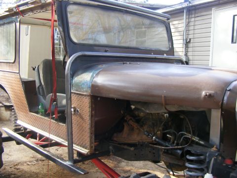 Modified Jeep CJ-5 with diamond plate side panels and roll cage