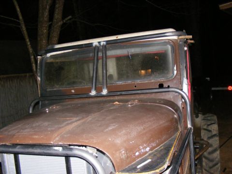 Custom off-road vehicle with roll cage, brown hood, and large tires