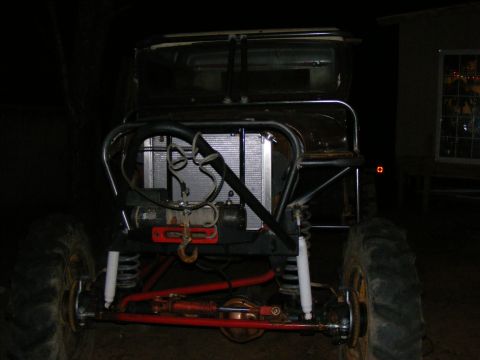 Front view of a heavily modified off-road vehicle with a winch and large tires