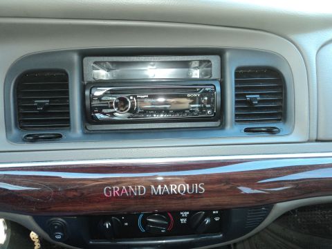 2004 Mercury Grand Marquis - The interior of a Grand Marquis features wood trim and an aftermarket stereo system.