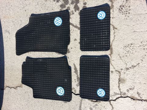 2002 Volkswagen Jetta - Set of four Volkswagen rubber floor mats with logos are displayed on a concrete surface.
