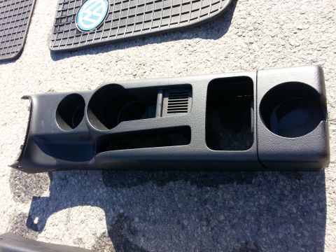 2002 Volkswagen Jetta - A Volkswagen floor mat with the logo is visible behind a car's dashboard trim piece.