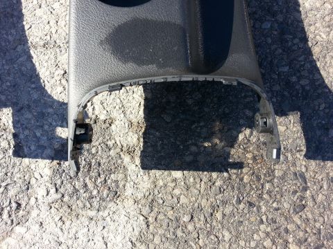 2002 Volkswagen Jetta - A close-up view of a detached black plastic interior trim piece with visible mounting clips.