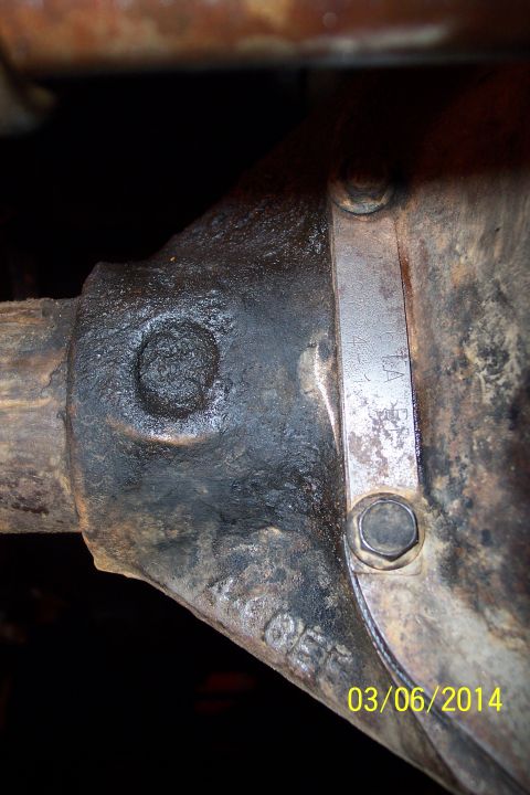 1973 Ford F-250 - A metal tag on a vehicle's axle housing displays identification numbers and a date.