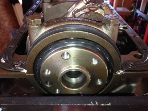 1996 Ford Bronco - Close-up of an engine block showing the crankshaft seal and front cover gasket.
