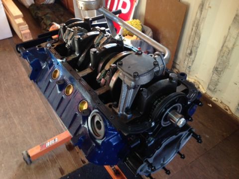 1996 Ford Bronco - Engine block assembly with crankshaft and connecting rods visible, resting on an orange stand.