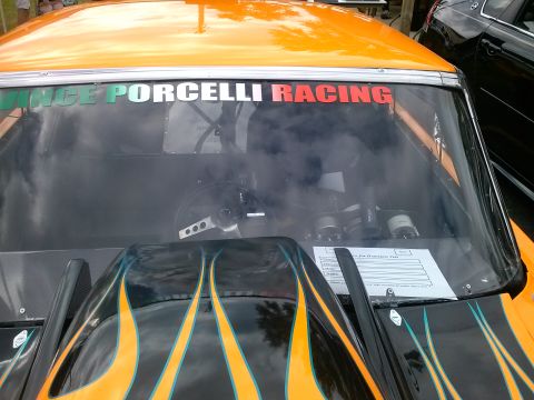 1960 Ford Falcon - The interior of a race car is visible, a flame-painted hood and a banner reading "Porcelli Racing" across the windshield.