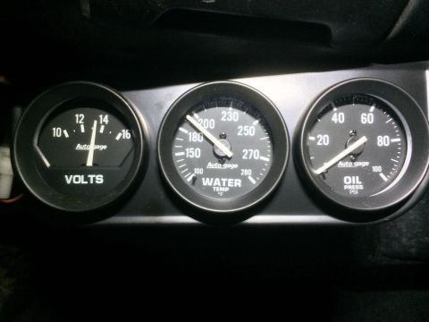 1964 Ford Ranchero - Dashboard gauges showing voltage, water temperature, and oil pressure readings.
