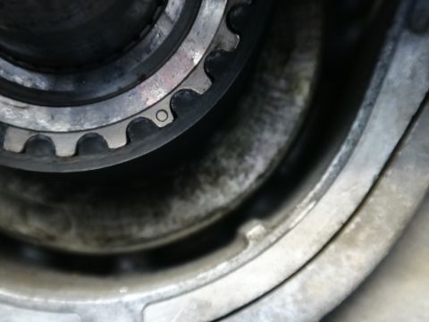 1993 Ford Taurus - A close-up view of a toothed timing belt pulley and its surrounding metal housing.