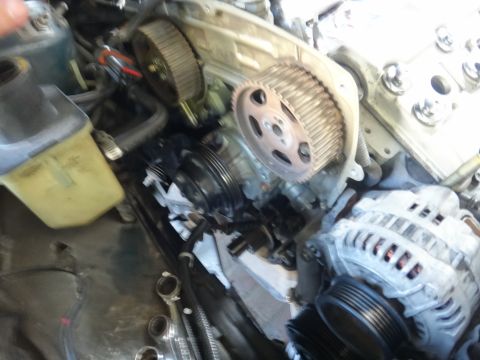1993 Ford Taurus - Close-up view of engine timing belt components, including pulleys and alternator.