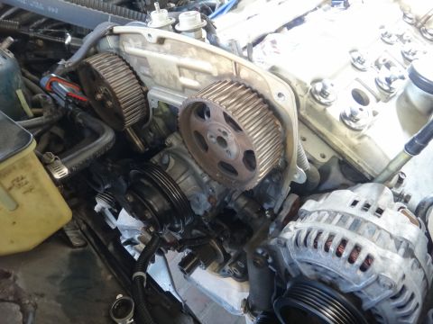 1993 Ford Taurus - The engine's timing belt system and alternator are visible in this close-up view.