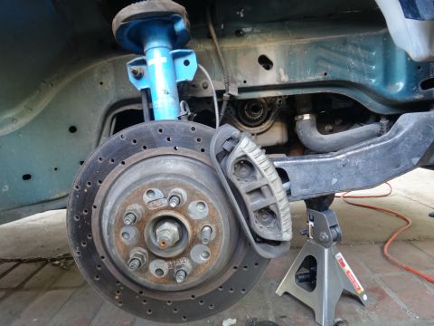 1993 Ford Taurus - Car's front brake assembly and suspension components are shown, with the engine partially visible in the background.