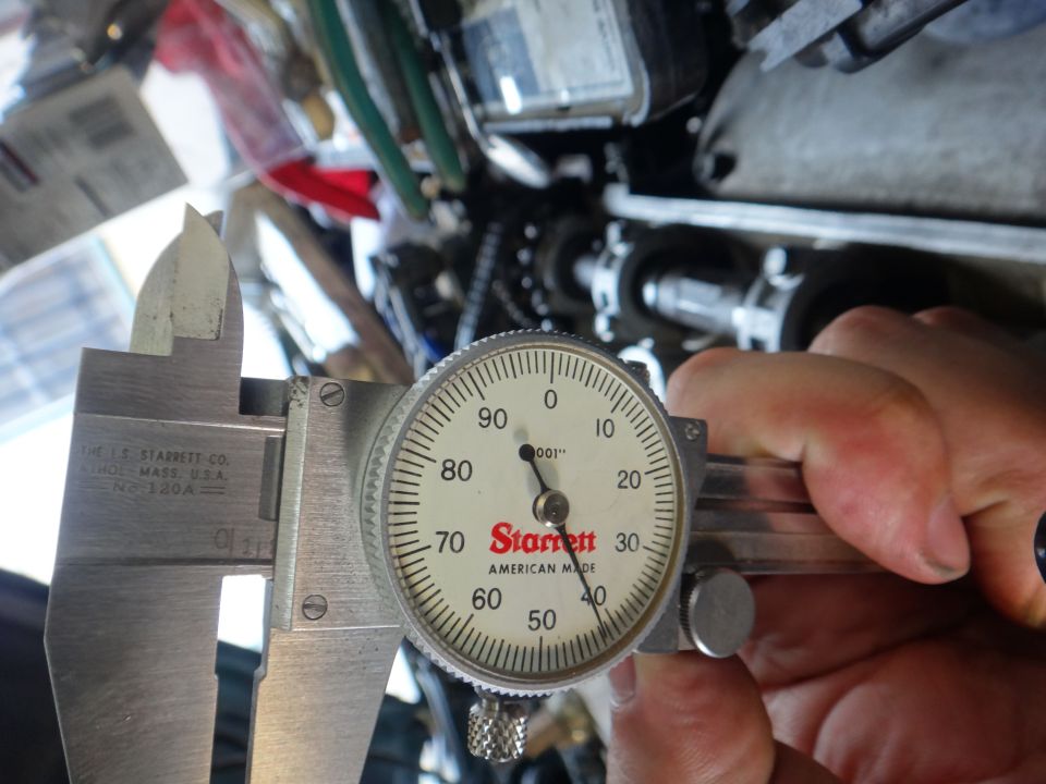 Starrett dial caliper measuring an engine component