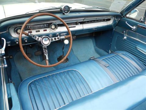 1964 Ford Ranchero - The interior of a 1964 Ford Ranchero shows off its blue vinyl seats and classic dashboard.