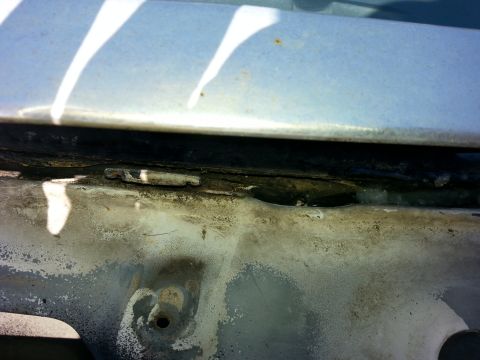 1992 Ford Bronco - this small hole, which I'm pretty sure it there to drain water into the trough is underneath the windshield trim..it was a little clogged u…