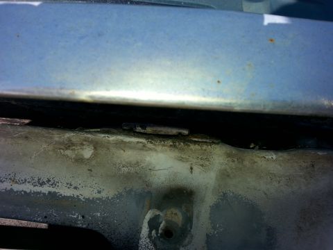 1992 Ford Bronco - Engine bay seam with visible dirt and rust accumulation.