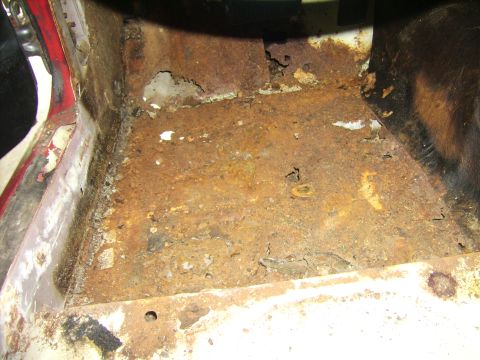 1968 Ford Mustang - Extensive rust damage is visible on the vehicle's floor pan, indicating significant structural compromise.