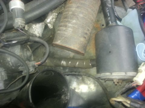 1994 Ford Bronco - Close-up view of various engine parts, including hoses and electrical connectors.