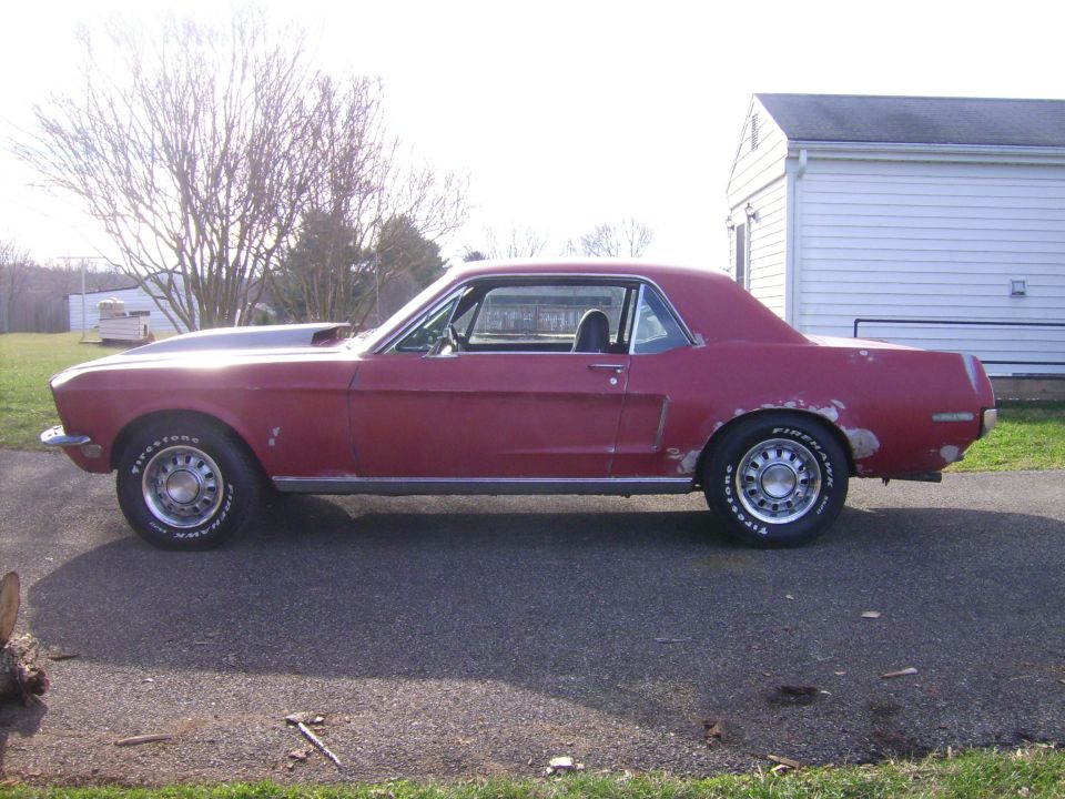 1968 Ford Mustang coupe with a hood scoop, seen from the side