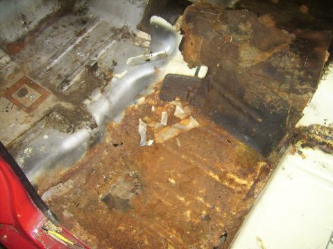 1968 Ford Mustang - Extensive rust damage is visible on the interior floor of the vehicle.