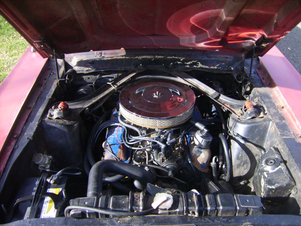 1968 Ford Mustang engine bay with V8 engine, air cleaner, and battery