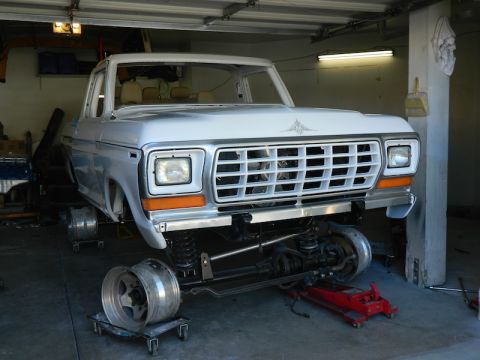 1979 Ford Bronco - Front view of a 1979 Ford Bronco undergoing repairs in a garage.