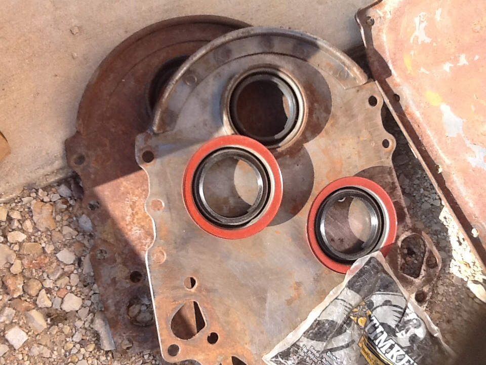 Engine crankshaft seal housing with three red-lipped seals installed