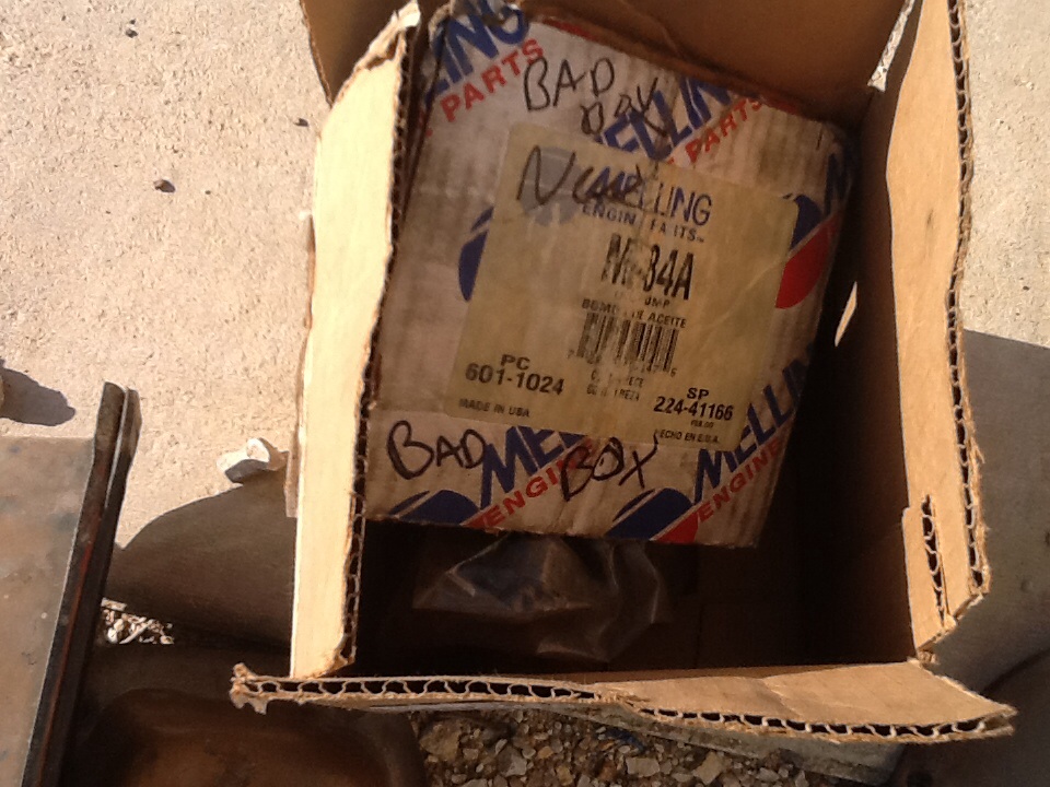 Cardboard box with Mellings M-34A engine parts and handwritten notes