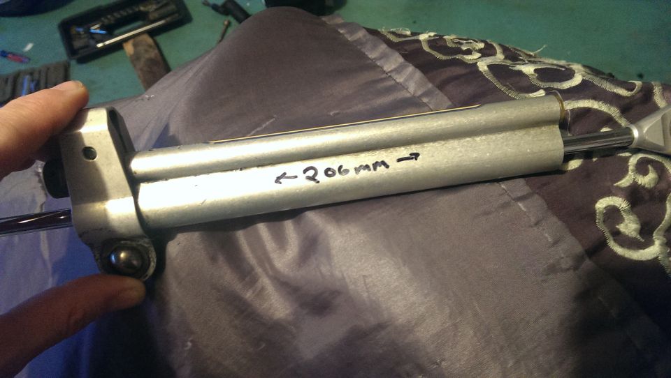 Close-up of a shock absorber with '206mm' written on it