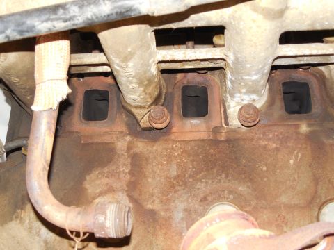 1983 Ford Bronco - Before installing the new manifolds, I sanded off as much of the soot & rust as I could from the mating surfaces. Later, I rinsed them with…