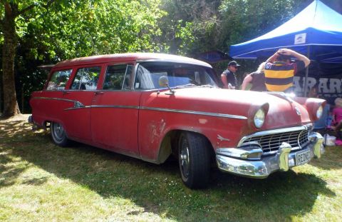 1964 Mercury Monterey - This red station wagon, likely a 1955 model, features a distinctive chrome grille and bumper.