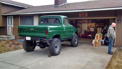 1967 Ford F-250 - This modified 1967 Ford F-250 pickup features a lifted suspension and oversized tires.