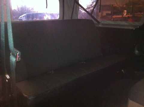 1982 Ford Bronco - Interior view of a vehicle's rear bench seat, with another vehicle seen through the back window.