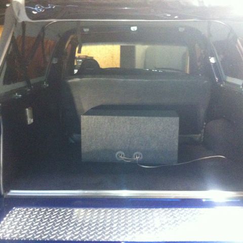 1982 Ford Bronco - The cargo area of the SUV contains a carpeted subwoofer box with wiring.