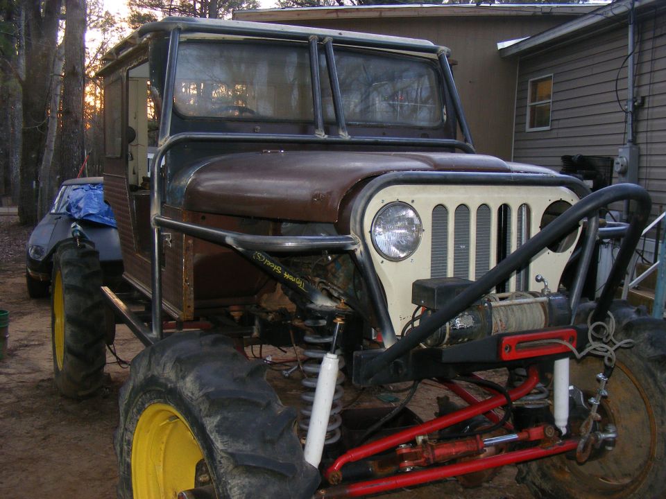 Modified Jeep CJ-5 with tractor tires, roll cage, and winch