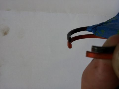 2002 Chrysler 300M - A hand holds a detached car interior trim piece against a white background.