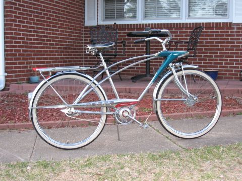1994 Ford Bronco - A vintage bicycle with whitewall tires and chrome accents is parked outside a brick house.
